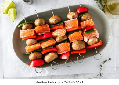 raw salmon skewers with vegetables. cooking summer recipe on marble