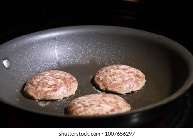 Raw Sausage Patties In Frying Pan