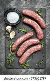 Raw Sausages On Slate, With Herbs And Spices.  Overhead View.