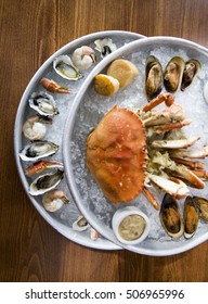 Raw Seafood Tower Of Crab, Mussels, Oysters, Shrimp And Shellfish Served On Ice Platter