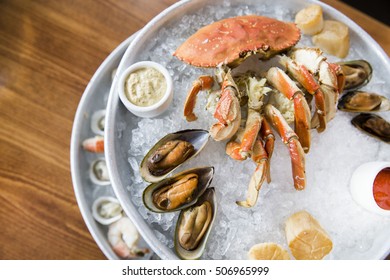 Raw Seafood Tower Of Crab, Mussels, Oysters, Shrimp And Shellfish Served On Ice Platter