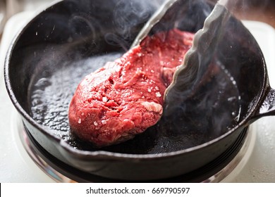 Raw seasoned angus steak fried on vegetable oil, iron cast - Powered by Shutterstock