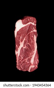 Raw Sirloin Beef Steak, Overhead View. Single Raw Striploin Steak From Marbled Beef Isolated On Black Background. Black Angus Beefsteak Meat. Raw Tenderloin Marble Steak. Uncooked Prime Beef Steak.