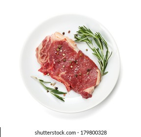 Raw Sirloin Steak With Rosemary And Spices On Plate. Isolated On White Background