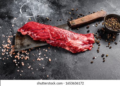 Raw Skirt, Machete Steak On A Meat Cleaver. Black Background. Top View