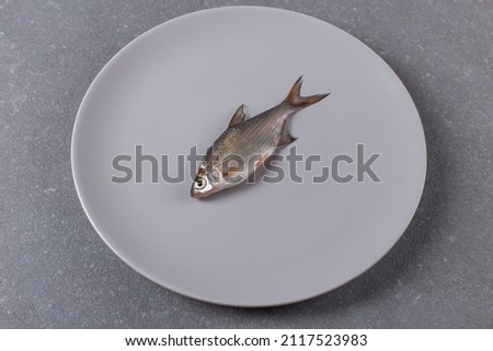 A raw slave on plate. The concept of killing a living being, disgusting food.