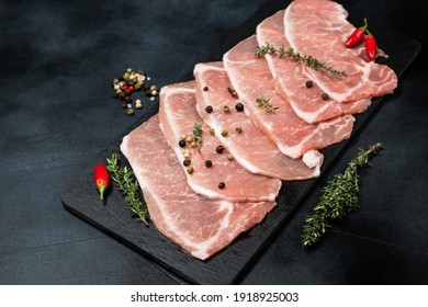 Raw Sliced Pork. Black Background. Top View. Space For Text