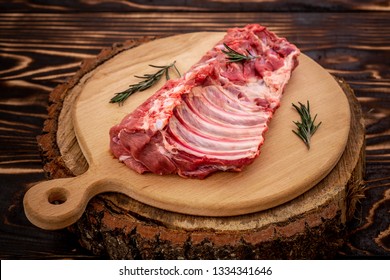 Raw sliced pork ribs on wooden serving board, Close up on wooden background. Food concept. top view.