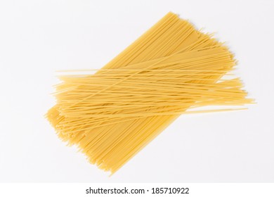 Raw spaghetti isolated on white background. - Shutterstock ID 185710922