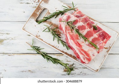 Raw Spare Ribs With A Rosemary. Top View