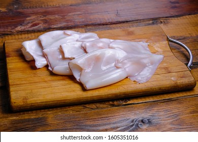 raw squid composition on a wooden background