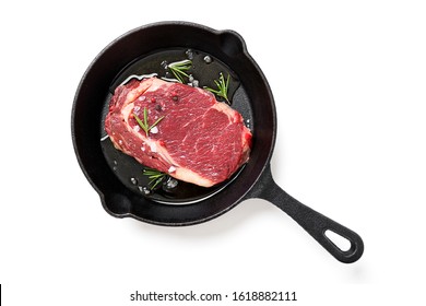 Raw steak on cast iron frying pan. isolated on white background - Powered by Shutterstock