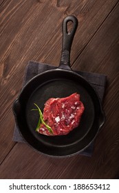 Raw Steak On Cast Iron Frying Pan 