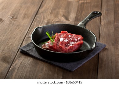 Raw Steak On Cast Iron Frying Pan 