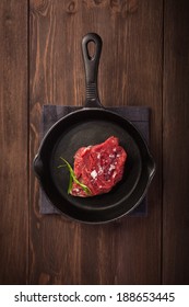 Raw Steak On Cast Iron Frying Pan 