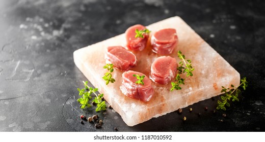 Raw Steak Ribeye on Himalayan pink salt block on dark  background - Powered by Shutterstock