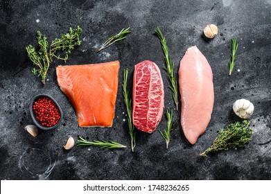 Raw Steaks. Beef Top Blade, Salmon Fillet And Turkey Breast. Organic Fish, Poultry And Beef Meat. Black Background. Top View