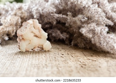 Raw Stilbite Crystal Sample On Wood With Copy Space. Stilbite Is Tectosilicate Mineral Of Zeolite Group. Helps To Heal Pain And Trauma In Spiritual Pactice