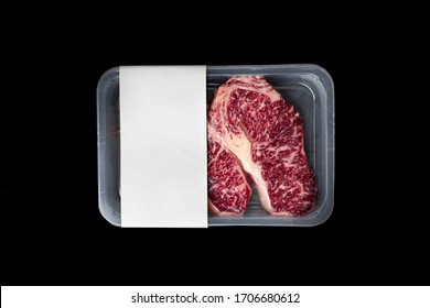 Raw Striploin marbled beef steak vacuum Packed isolated on black, logo mockup
