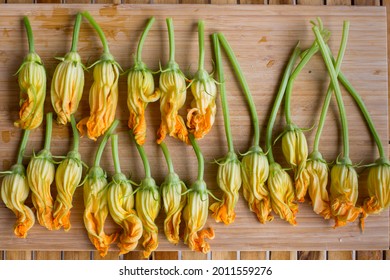 Raw Stuffed With Provolone Cheese Zucchini Flowers,  Squash Blossoms On The Wooden Board, Calabria Italy