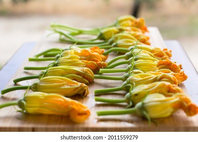 Raw Stuffed With Provolone Cheese Zucchini Flowers,  Squash Blossoms On The Wooden Board, Calabria Italy