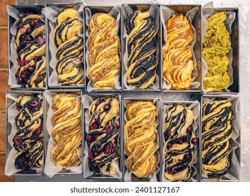 Lot of raw sweet bread babka with different fillings in a baking pan ready to bake