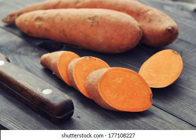 Raw sweet potatoes on wooden background closeup - Shutterstock ID 177108227