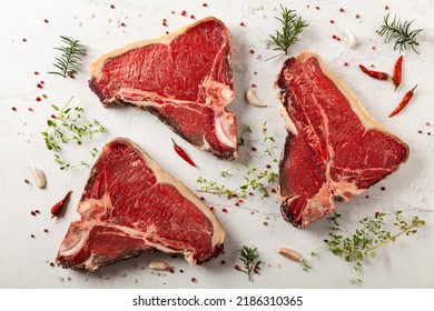 Raw T Bone Steak, With Herbs. Stone Bright Background