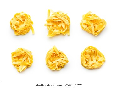 Raw tagliatelle pasta isolated on white background.