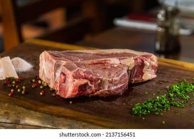 Raw Tbone With Spices On The Wood Table