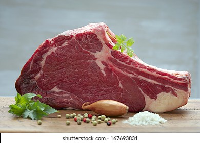 Raw T-Bone steak  on wooden board  prepared to Grill