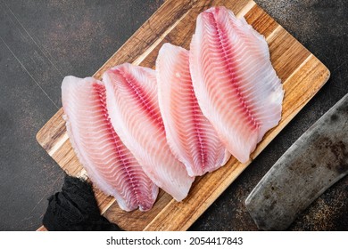 Raw Tilapia Fish Fillet Meat Cuts, On Old Rustic Background, Top View