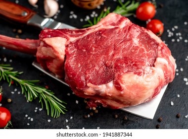 Raw Tomahawk Beef Steak With Spices On Stone Background