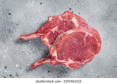 Raw Tomahawk Beef (veal) Steak On Butcher Table. Gray Background. Top View.