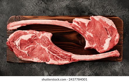 Raw tomahawk steak on wooden board - Powered by Shutterstock