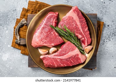 Raw Topside Sirloin Beef Cut On Steel Plate With Spices. Gray Background. Top View.