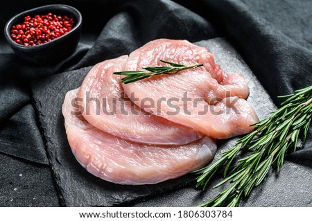 Raw Turkey breast steaks. organic poultry meat. Black background. Top view Сток-фото © 