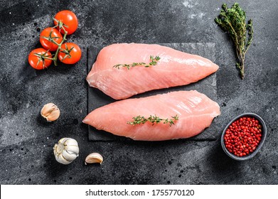 Raw Turkey Breasts. Fillet Steak. Black Background. Top View