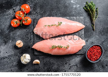 Raw Turkey Breasts. Fillet steak. Black background. Top view Сток-фото © 
