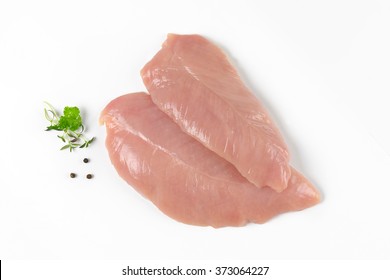 Raw Turkey Breasts With Spice And Herbs On White Background