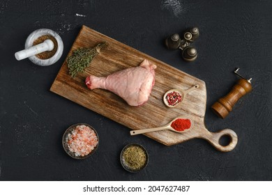 Raw Turkey Drumstick With Skin On Wooden Board