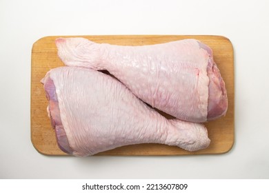 Raw Turkey Leg On A Wooden Board On A White Background. Fresh Turkey Meat