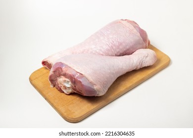 Raw Turkey Leg On A Wooden Board On A White Background. Fresh Turkey Meat