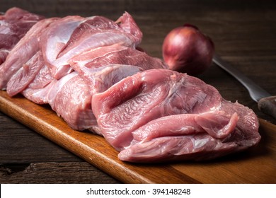 Raw Turkey Meat On A Wooden Chopping Board. Dark Light.