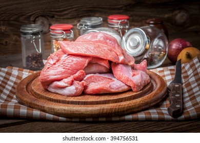 Raw Turkey Meat On A Wooden Chopping Board. Dark Light.