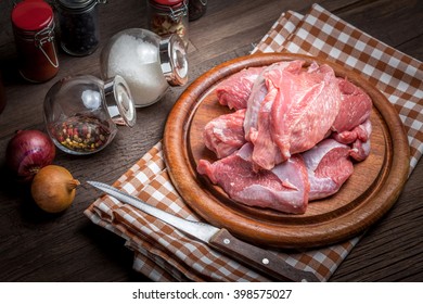 Raw Turkey Meat On A Wooden Chopping Board. Dark Light.