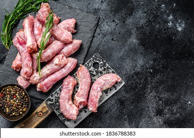 Raw Turkey neck meat on a cutting board. Black background. Top view. Copy space - Shutterstock ID 1836788383