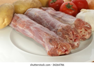 Raw Turkey Neck With Vegetables On A Plate