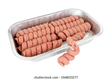 Raw turkey twizzlers in a foil tray, turkey meat formed into spirals isolated on a white background
