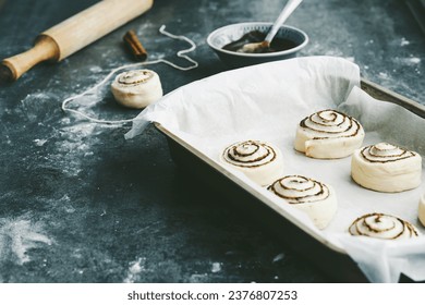 Raw, unbaked cinnamon buns resting. Cooking of healthy buns from alternative flours. Vegan bread. Festive food. High quality photo - Powered by Shutterstock